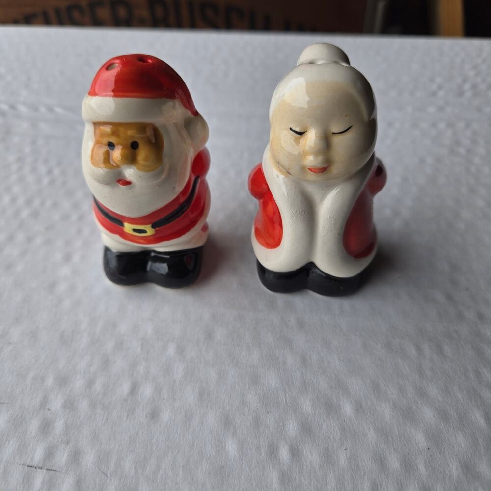 Vintage Mr and Mrs Claus holding presents salt and pepper shakers